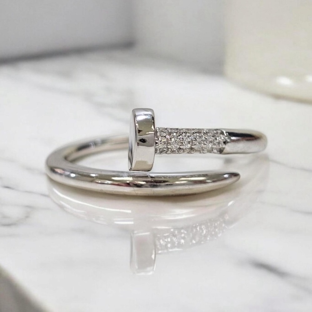 Sterling silver .925 and white created sapphire iconic nail ring.
